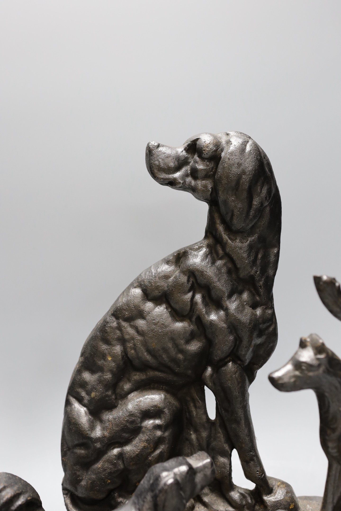 Four cast iron ‘dog’ door stops, 32cm